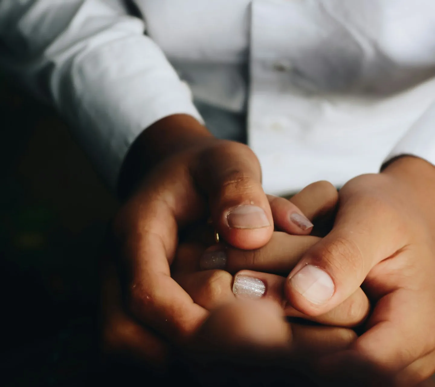 A carer holding the hand of an older person